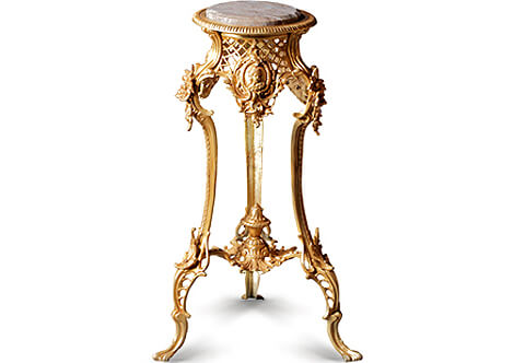 A French Louis XV finely chiseled gilt-ormolu Rococo style tripod Guéridon, The circular marble top inset in a beaded frieze above a pierced concave sides lattice apron centered to each side with a cartouche decorated with bas-relief cherub terminating with a rococo suspended acanthus leaf, The turning splayed legs headed with a bouquet of blossoming flowers and acanthus works, terminating with pierced design and acanthus leaves to each leg and connected with a leafy stretcher centered with an urn of prosperity.